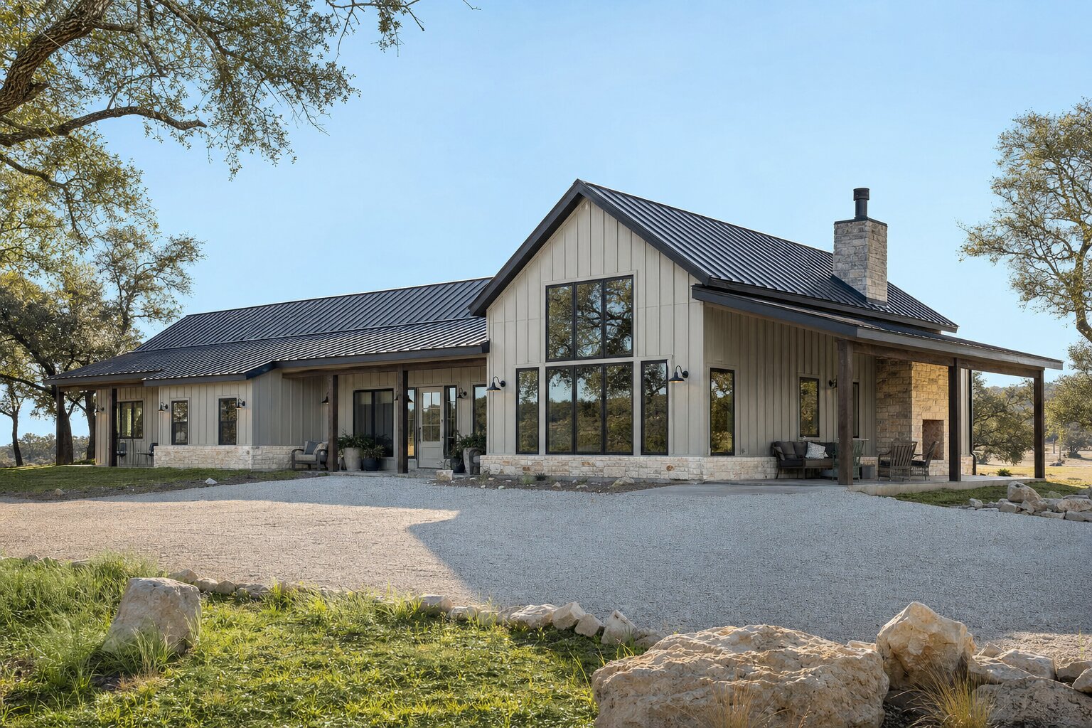 Modern barndominium with a standing-seam metal roof and stone accents on Texas Hill Country acreage
