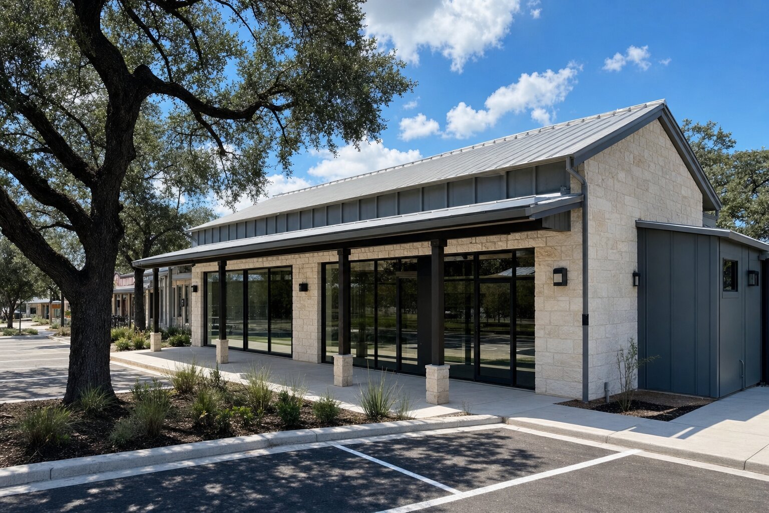 Small modern commercial building on a Texas Hill Country main street with parking and oak trees