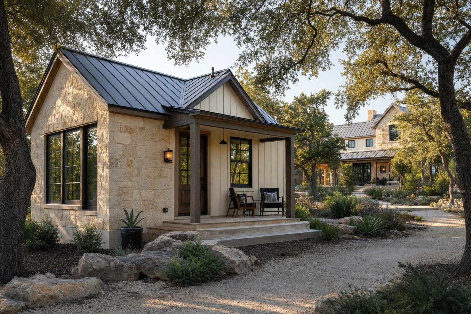 Detached stone casita guest house with a metal roof and covered porch on a Texas Hill Country property